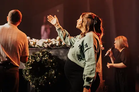 four guitarists on tiered stage