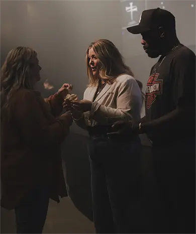 pastor standing on stage hands folded