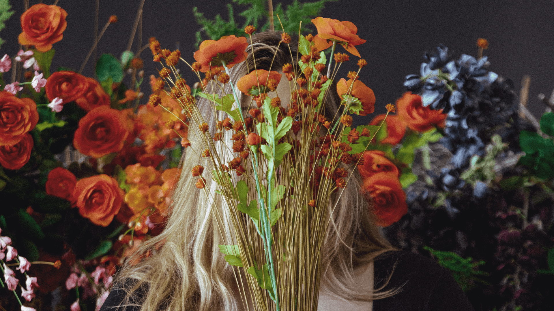 girl with flowers in front of face
