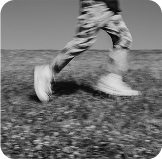 person running through field black and white