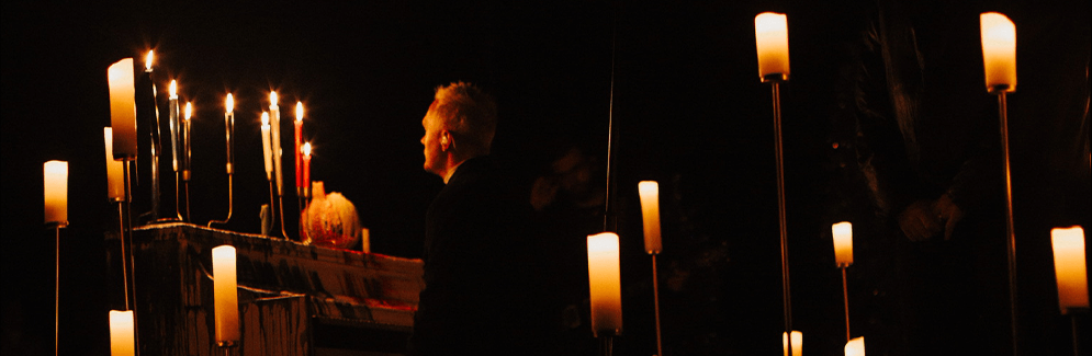 man looking at candles