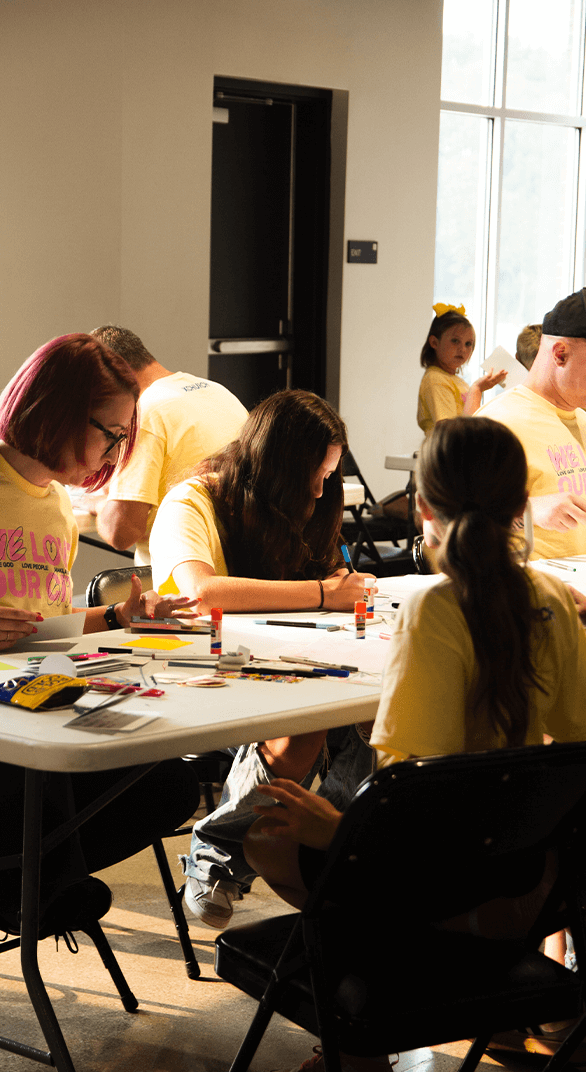 people at table working on craft projects