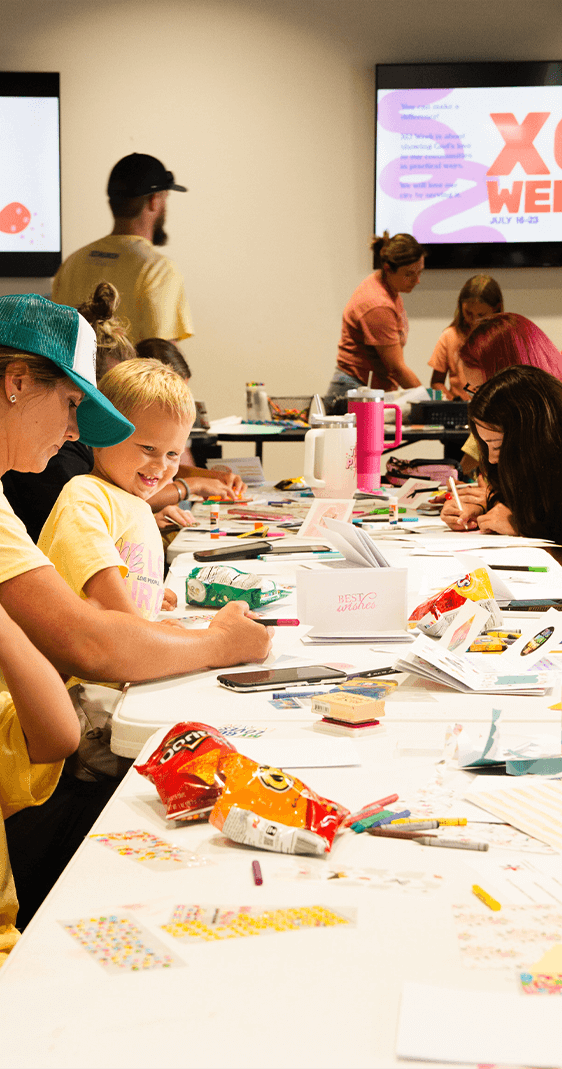 woman and baby at table working on craft
