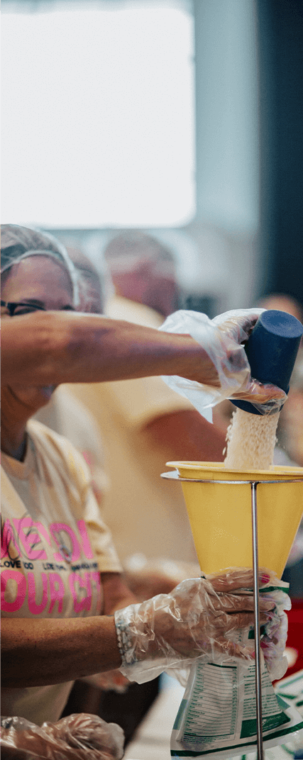 woman pouring rice into funnel