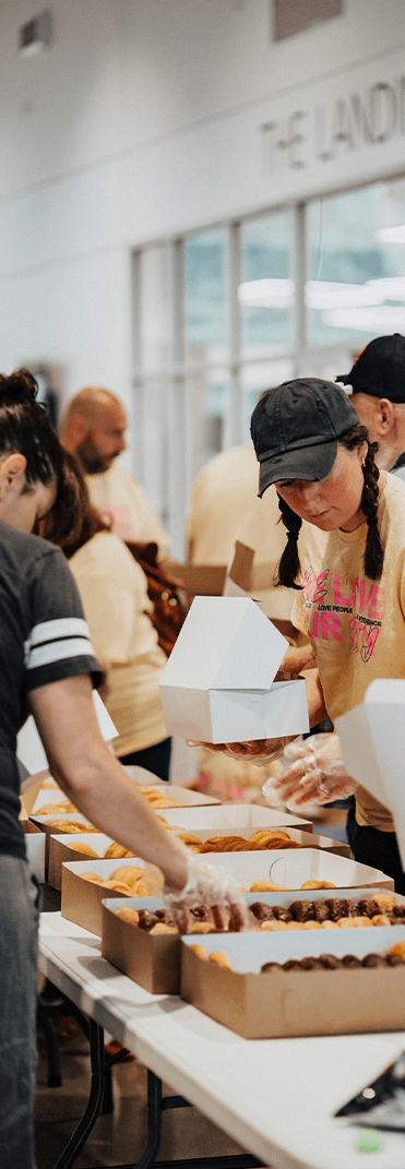 women working on packing food into boxes